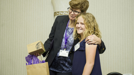 Hadlee Fuller, a yound STEMist giving General Wolfenbarger her gift on behalf of AFTAC